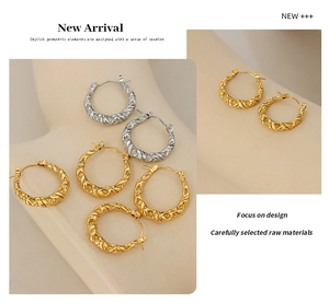 Macro view of minimalist twisted texture hoop earrings in gold and silver finishes