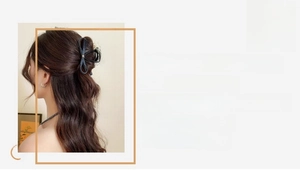Detailed view of an elegant acetate butterfly hair claw clip worn by a model in a cozy setting