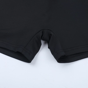 Close-up of reinforced stitching and high-elastic fabric on black athletic shorts