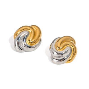 Macro shot of two-tone gold and silver twisted hoop earrings in a vortex design