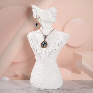 White resin female mannequin bust for jewelry display featuring necklace and earrings