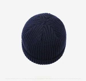 Top down view of navy blue ribbed knit beanie showing thick texture and crown stitching