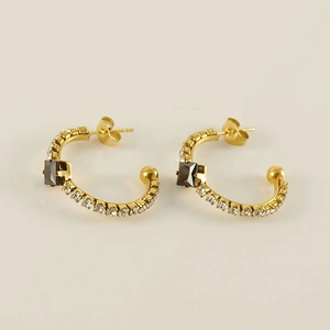 Detail of 18K gold C-shaped hoop earrings with crystals and square brown gemstone