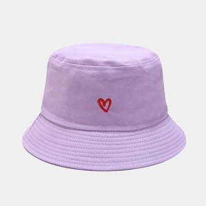 Detailed view of red heart embroidery on light purple cotton bucket hat with fine stitching