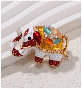 Detailed view of vintage elephant brooch with colorful enamel and inlaid gemstones