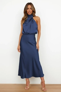 Detailed shot of an elegant navy blue satin midi dress featuring a sophisticated halter neck
