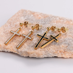 Detailed shot of gold stainless steel cross earrings with black and white rhinestones