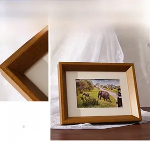 Detail of solid wood photo frame with wide beveled edges and natural grain texture