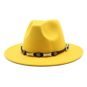 Detail of yellow wool fedora featuring a black leather band with silver star metal studs