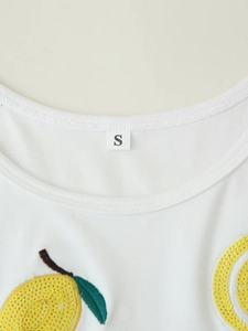 Detail of ribbed knit neckline with sequined lemon embroidery and size S label