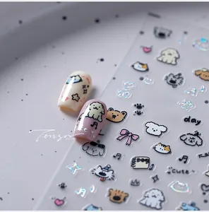 Detailed view of laser cartoon nail stickers featuring bichon dogs and teddy bears
