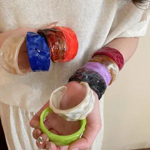 Chunky acrylic resin bangles featuring irregular wavy texture in assorted vibrant colors