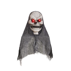 Glowing red-eyed Halloween skull prop with tattered grey gauze for spooky outdoor decoration