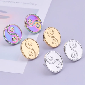 Close-up of heart-based Yin Yang stud earrings in rainbow, gold, and silver finishes