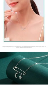 Detail of S925 silver safety pin necklace featuring micro-set moon and star pendants