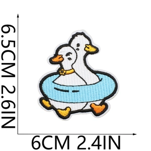 Cartoon duck embroidery patch with blue swim ring measuring 6.5x6 cm for clothing
