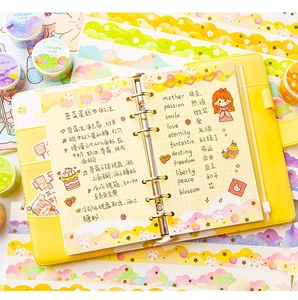 Close-up of yellow 6-ring binder with strawberry cloud washi tape and stickers decoration