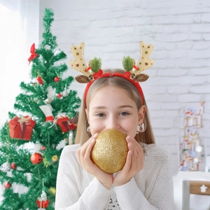Christmas reindeer antler headband with gold glitter, bells and pine needles on model