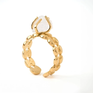 Detailed macro view of an adjustable gold ring featuring a raw white crystal stone