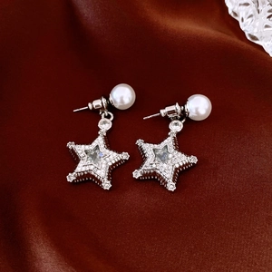 Detail of silver star pendant earrings with pearls and pavé cubic zirconia inlay