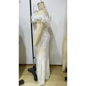 Detail of white off-shoulder gown with silver sequins and layered tulle ruffles on a plus-size mannequin