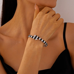 Gros plan d'un bracelet tennis en zircons noirs et blancs marquise sur le poignet