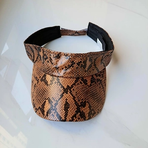 Detail of snake print visor hat showing inner sweatband and product care label