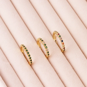 Detailed view of three 18K gold plated adjustable rings with green and colorful zircons