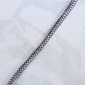 Macro shot of black spiral elastic strap detail over breathable white mesh fabric