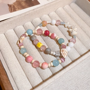 Charming beaded bracelets with cat opal stone and leaf charms on soft velvet tray
