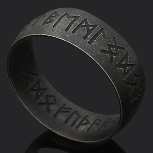 Detail view of vintage titanium steel ring featuring engraved Norse Viking runes
