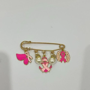 Détail de la broche contre le cancer du sein avec rubans roses et perles nacrées