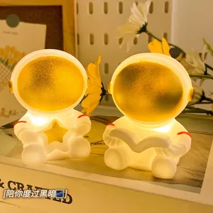 Creative astronaut night light gift set featuring sitting space figures on books