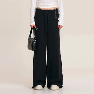 Detail of black wide-leg outdoor sports pants featuring an adjustable drawstring waist