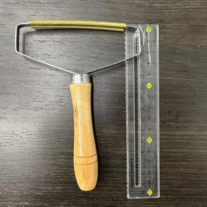 Manual lint remover with wooden handle and copper head for clothes on a wooden desk
