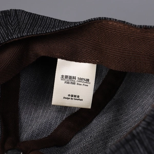 Close-up of 100% cotton inner lining and brown herringbone sweatband on grey octagonal cap