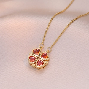 Golden titanium steel necklace with red zircon hearts in a four-leaf clover design