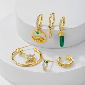 Bohemian gold plated earrings set with green emerald stones and star tassel charms