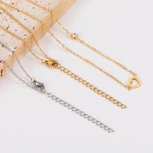 Detailed shot of gold and silver necklaces with heart and cubic zirconia charms
