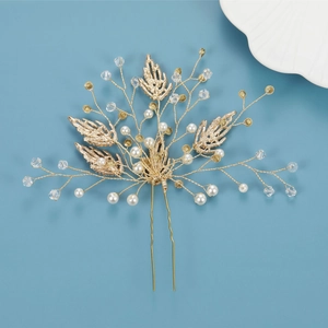 Elegant gold bridal hair pin with pearls and crystal leaves for wedding hairstyle