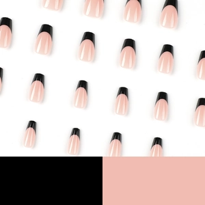 French tip press-on nails with black edges and nude pink base on a clean white background