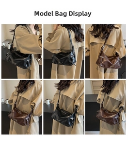 Detail view of large tote bag with adjustable straps and metallic zipper accents
