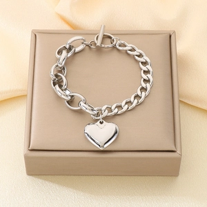 Detail view of silver stainless steel chunky chain bracelet with OT toggle and heart charm
