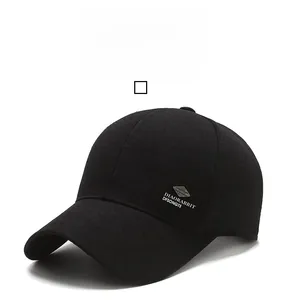 Detail of black twill cotton baseball cap featuring metal logo and embroidery on the side