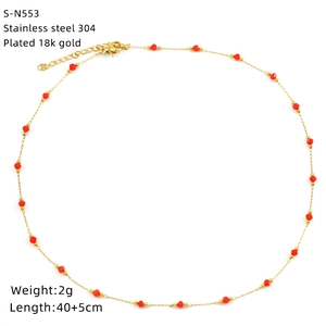 Detail view of gold-plated stainless steel necklace with red glass beads and size specs