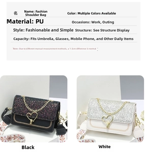 Detail of PU leather crossbody bags with heart lock, gold chains and ethnic strap