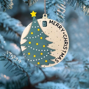 Wooden Santa Slider Christmas Countdown Calendar hanging on a snowy pine branch