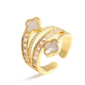 Gold-plated clover ring with white shell and sparkling zircons in a layered open design