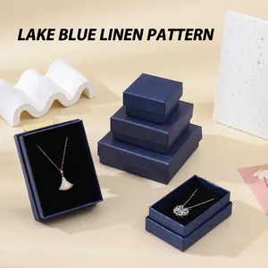 Macro shot of lake blue textured jewelry boxes with necklace inserts for premium storage