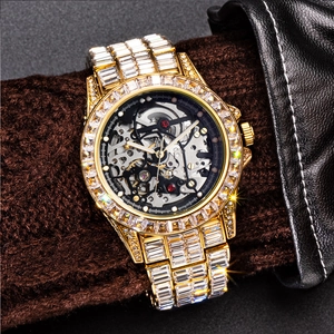 Close-up of luxury gold-tone iced out automatic skeleton mechanical watch on wrist